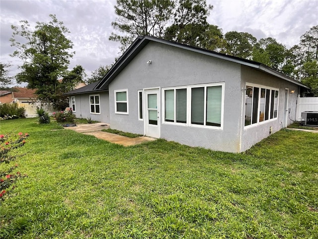 41 Brewster Ln, Palm Coast, FL 32137 - back of property featuring stucco siding and cooling unit