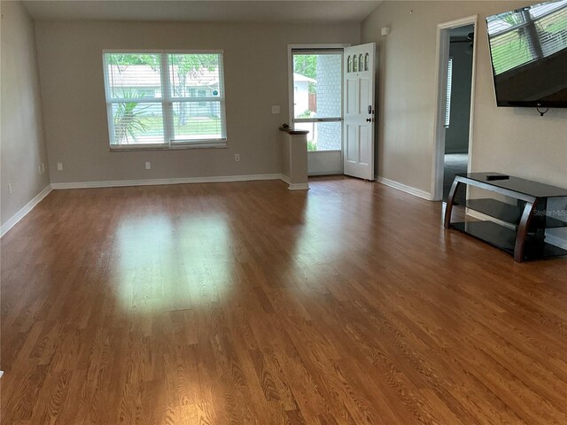 41 Brewster Ln, Palm Coast, FL 32137 - unfurnished living room featuring wood finished floors and baseboards