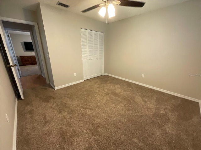 41 Brewster Ln, Palm Coast, FL 32137 - unfurnished bedroom with dark carpet, a closet, baseboards, and ceiling fan