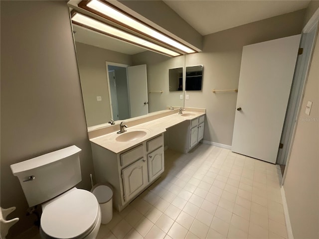 41 Brewster Ln, Palm Coast, FL 32137 - bathroom featuring toilet, double vanity, tile patterned floors, and baseboards