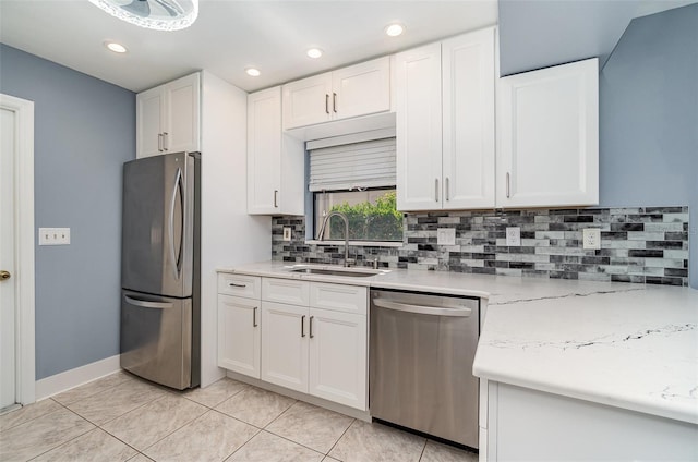 541 Wekiva River Ct Unit 94, Englewood, FL 34223 - kitchen with appliances with stainless steel finishes, a sink, white cabinetry, backsplash, and recessed lighting