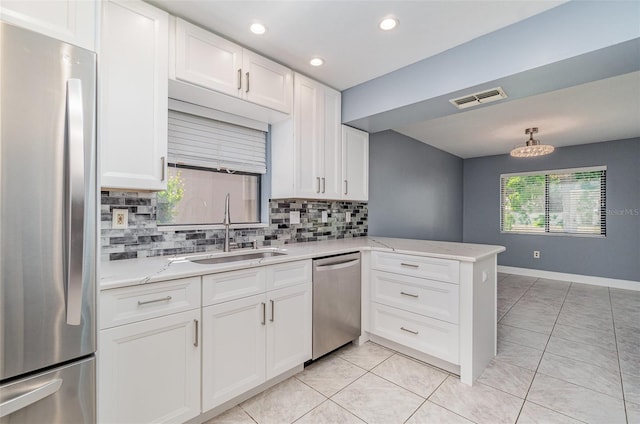 541 Wekiva River Ct Unit 94, Englewood, FL 34223 - kitchen featuring stainless steel appliances, a sink, decorative backsplash, white cabinetry, and light tile patterned floors