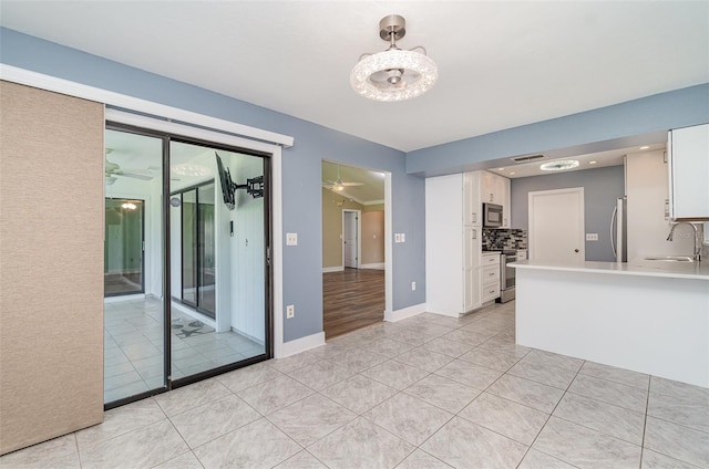 541 Wekiva River Ct Unit 94, Englewood, FL 34223 - unfurnished room with a sink, light tile patterned floors, baseboards, and a ceiling fan