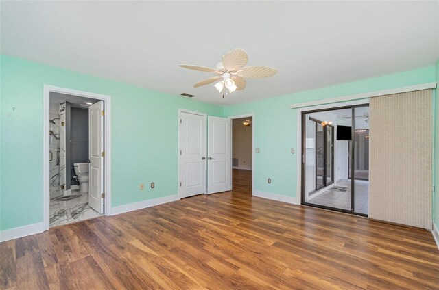 541 Wekiva River Ct Unit 94, Englewood, FL 34223 - unfurnished bedroom featuring wood finished floors, baseboards, connected bathroom, and ceiling fan