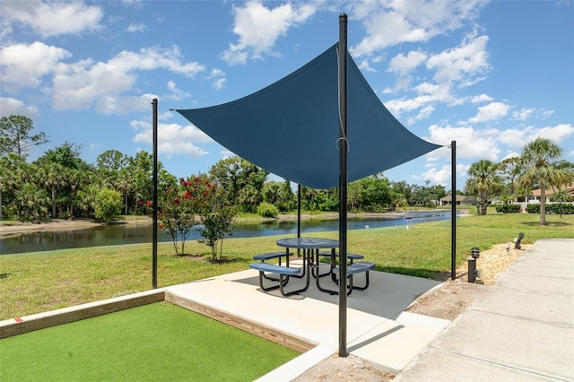541 Wekiva River Ct Unit 94, Englewood, FL 34223 - view of home's community featuring a lawn, a water view, and a patio area