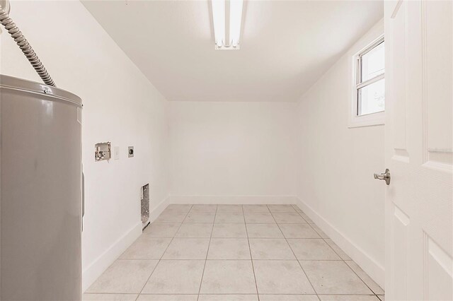 3129 Buttonwood Pl, Punta Gorda, FL 33950 - laundry area featuring water heater, hookup for an electric dryer, light tile patterned floors, baseboards, and hookup for a washing machine