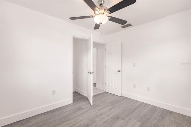 3129 Buttonwood Pl, Punta Gorda, FL 33950 - unfurnished bedroom featuring baseboards, light wood-style flooring, and ceiling fan
