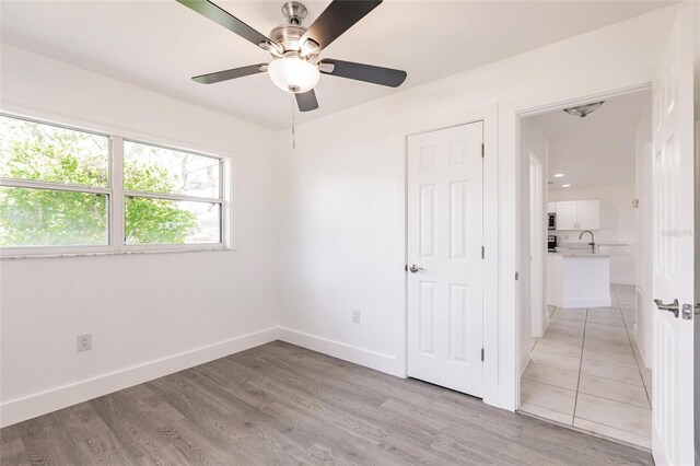 3129 Buttonwood Pl, Punta Gorda, FL 33950 - unfurnished bedroom with baseboards, light wood-type flooring, and a sink