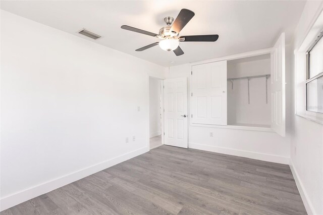 3129 Buttonwood Pl, Punta Gorda, FL 33950 - unfurnished bedroom featuring baseboards, wood finished floors, ceiling fan, and a closet