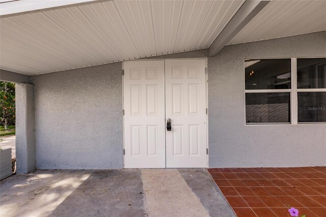 3129 Buttonwood Pl, Punta Gorda, FL 33950 - doorway to property featuring stucco siding