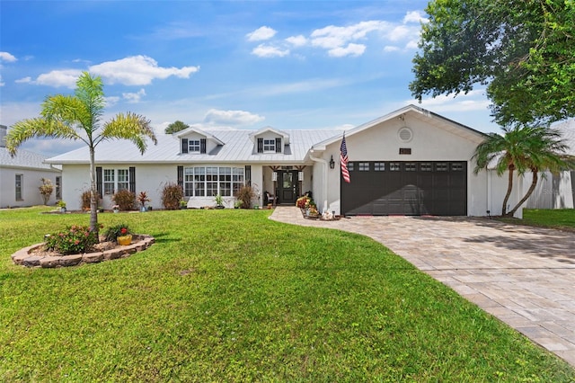 425 Corrientes Cir, Punta Gorda, FL 33983 - view of front facade featuring an attached garage, decorative driveway, stucco siding, and a front yard