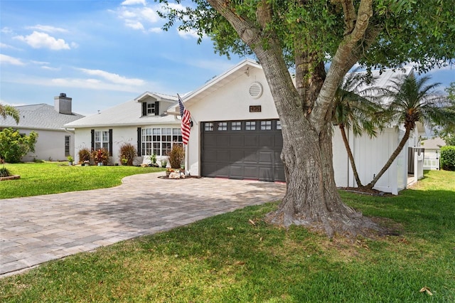 425 Corrientes Cir, Punta Gorda, FL 33983 - view of front of house with a garage, decorative driveway, a front lawn, and stucco siding