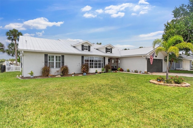 425 Corrientes Cir, Punta Gorda, FL 33983 - view of front facade featuring a garage, concrete driveway, stucco siding, metal roof, and central AC