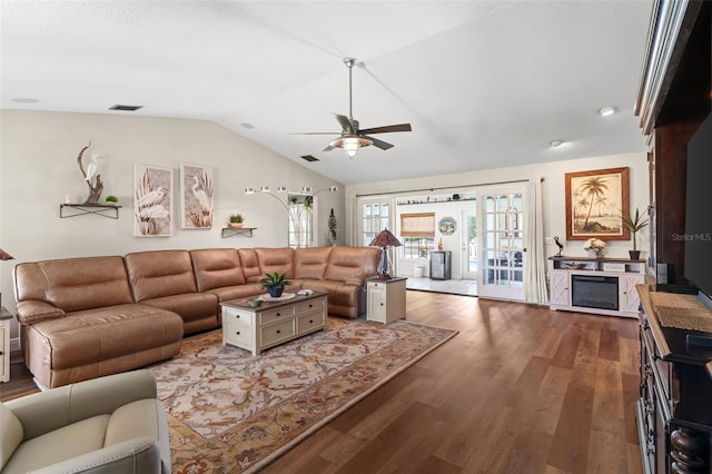 425 Corrientes Cir, Punta Gorda, FL 33983 - living room featuring vaulted ceiling, ceiling fan, wood finished floors, and a glass covered fireplace