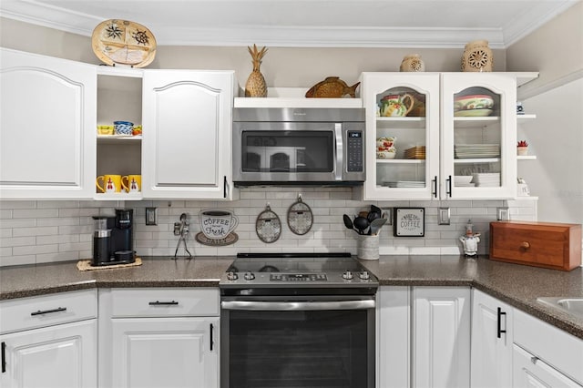 425 Corrientes Cir, Punta Gorda, FL 33983 - kitchen featuring appliances with stainless steel finishes, open shelves, dark countertops, white cabinetry, and decorative backsplash