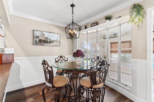 425 Corrientes Cir, Punta Gorda, FL 33983 - dining area with dark wood-style flooring, crown molding, wainscoting, and a chandelier