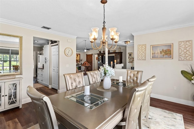 425 Corrientes Cir, Punta Gorda, FL 33983 - dining area with a chandelier, dark wood finished floors, crown molding, and baseboards