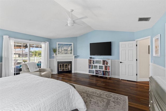 425 Corrientes Cir, Punta Gorda, FL 33983 - bedroom with vaulted ceiling, wood finished floors, a glass covered fireplace, ceiling fan, and baseboards