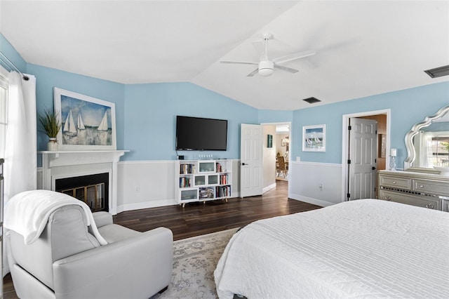 425 Corrientes Cir, Punta Gorda, FL 33983 - bedroom with wood finished floors, lofted ceiling, a ceiling fan, a glass covered fireplace, and baseboards