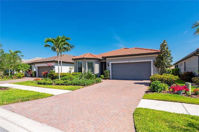 1470 Hyssop Loop, North Port, FL 34289 - view of front of property with stucco siding, a garage, decorative driveway, and a tiled roof