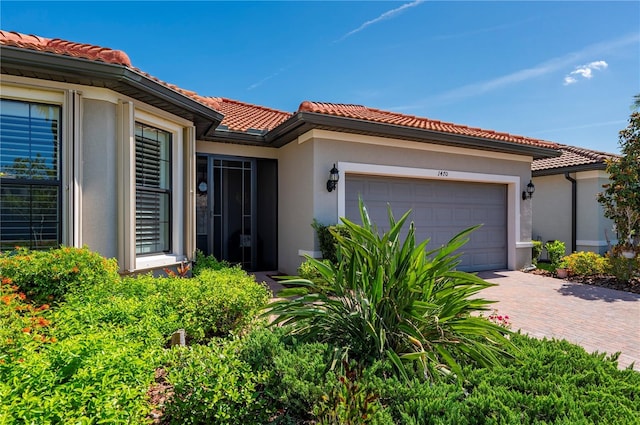 1470 Hyssop Loop, North Port, FL 34289 - view of front of home featuring stucco siding, a garage, and a tile roof