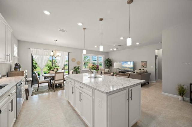 1470 Hyssop Loop, North Port, FL 34289 - kitchen with recessed lighting, a kitchen island, a chandelier, white cabinets, and light stone countertops