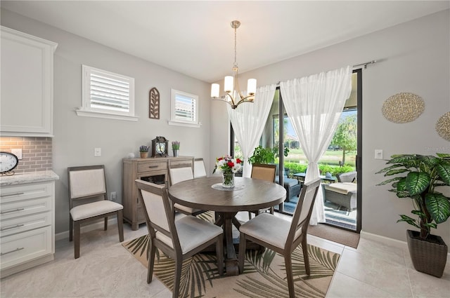 1470 Hyssop Loop, North Port, FL 34289 - dining area with a chandelier, baseboards, and light tile patterned floors