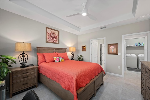 1470 Hyssop Loop, North Port, FL 34289 - bedroom featuring washer and clothes dryer, a raised ceiling, a ceiling fan, and baseboards