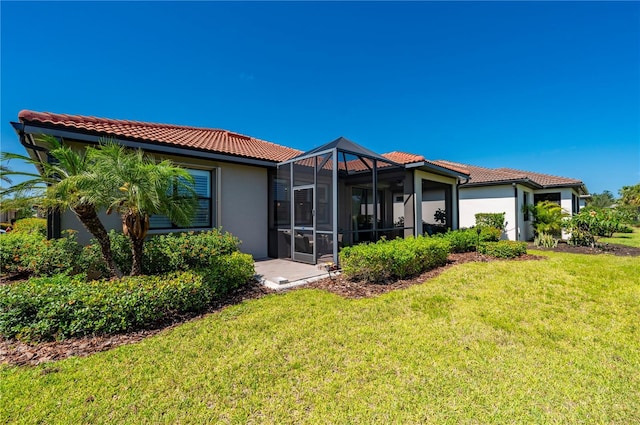 1470 Hyssop Loop, North Port, FL 34289 - back of property with a tiled roof, stucco siding, and a lawn