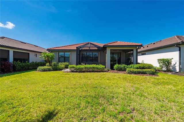 1470 Hyssop Loop, North Port, FL 34289 - back of property with a tile roof, a lawn, and stucco siding