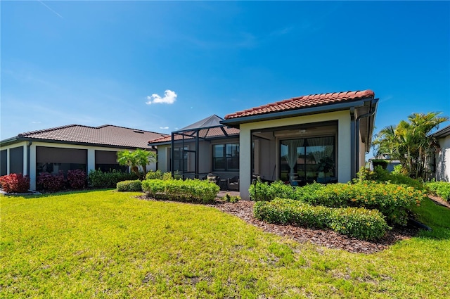 1470 Hyssop Loop, North Port, FL 34289 - rear view of property featuring a tile roof, a lawn, and stucco siding