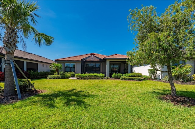 1470 Hyssop Loop, North Port, FL 34289 - mediterranean / spanish house featuring a tiled roof, stucco siding, and a front lawn