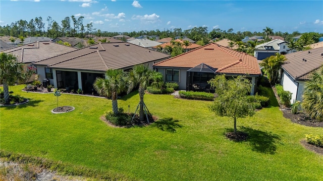 1470 Hyssop Loop, North Port, FL 34289 - back of house with a tile roof, a residential view, a yard, and stucco siding