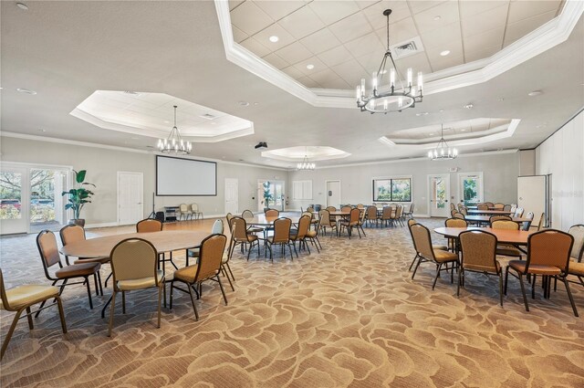 1470 Hyssop Loop, North Port, FL 34289 - dining area featuring a chandelier, a raised ceiling, crown molding, recessed lighting, and light stone finish floors