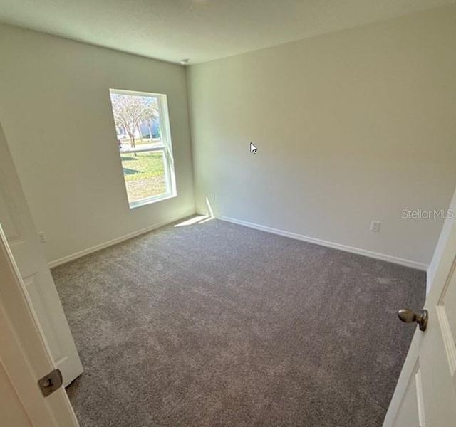 42 Peppercorn Ln, Palm Coast, FL 32164 - empty room with carpet floors and baseboards