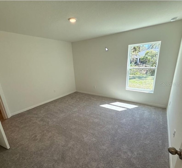 42 Peppercorn Ln, Palm Coast, FL 32164 - spare room featuring carpet and baseboards