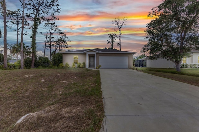 3799 Laredo Ave, North Port, FL 34288 - single story home featuring an attached garage, concrete driveway, a yard, and stucco siding