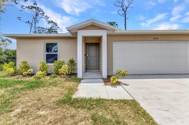 3799 Laredo Ave, North Port, FL 34288 - view of front of property featuring stucco siding, an attached garage, and concrete driveway
