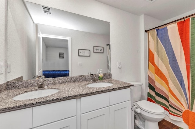 3799 Laredo Ave, North Port, FL 34288 - bathroom featuring double vanity, toilet, a shower with shower curtain, and a textured wall