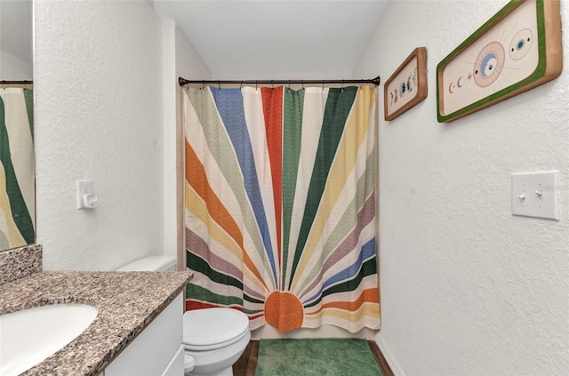 3799 Laredo Ave, North Port, FL 34288 - bathroom with vanity, toilet, a textured wall, and a shower with shower curtain