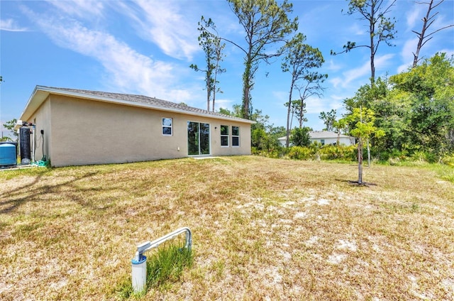 3799 Laredo Ave, North Port, FL 34288 - back of property featuring stucco siding and a yard