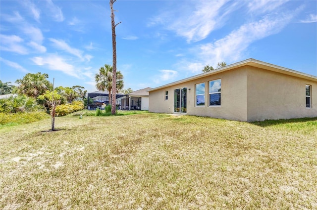 3799 Laredo Ave, North Port, FL 34288 - back of property with stucco siding and a yard