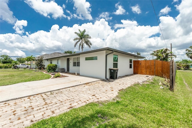 416 Allen St, Punta Gorda, FL 33950 - rear view of house with stucco siding and driveway