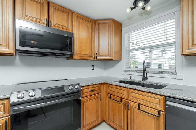416 Allen St, Punta Gorda, FL 33950 - kitchen with stainless steel electric stove, dishwasher, a sink, light stone counters, and brown cabinetry
