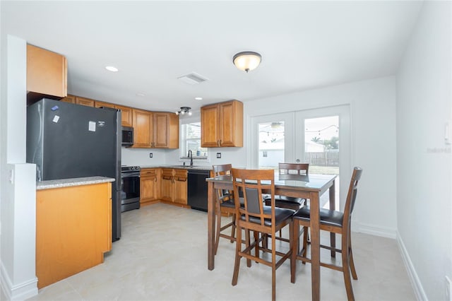 416 Allen St, Punta Gorda, FL 33950 - kitchen with stainless steel appliances, a sink, light countertops, french doors, and light flooring