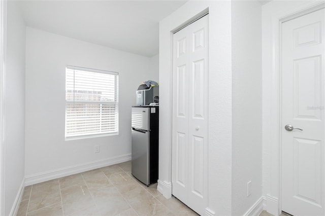 416 Allen St, Punta Gorda, FL 33950 - unfurnished bedroom featuring freestanding refrigerator, a closet, and baseboards