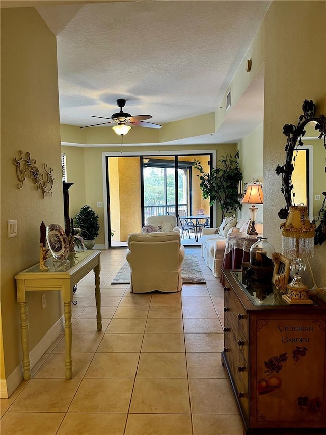 96 Vivante Blvd Unit 9622, Punta Gorda, FL 33950 - living area with ceiling fan, a textured ceiling, light tile patterned flooring, and baseboards