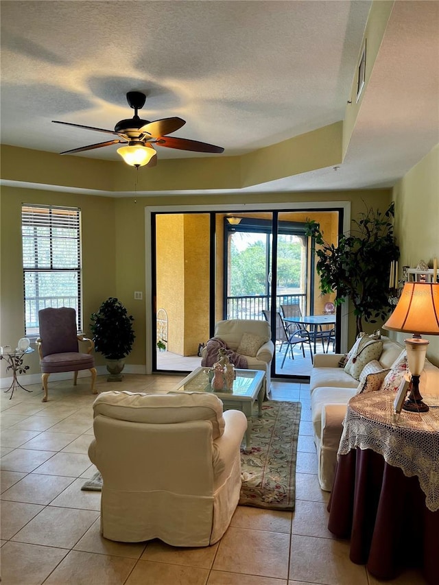96 Vivante Blvd Unit 9622, Punta Gorda, FL 33950 - living room featuring light tile patterned floors, a textured ceiling, plenty of natural light, ceiling fan, and baseboards
