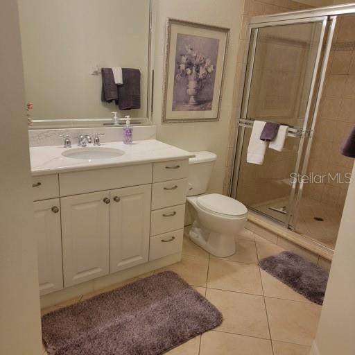 96 Vivante Blvd Unit 9622, Punta Gorda, FL 33950 - full bathroom featuring vanity, a stall shower, tile patterned floors, and toilet