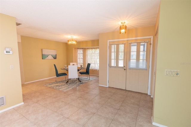 238 Mark Twain Ln, Rotonda West, FL 33947 - foyer with a chandelier, baseboards, and light tile patterned flooring